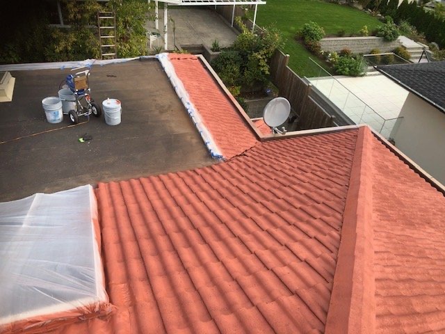 Tile roof section replaced beside a flat roof