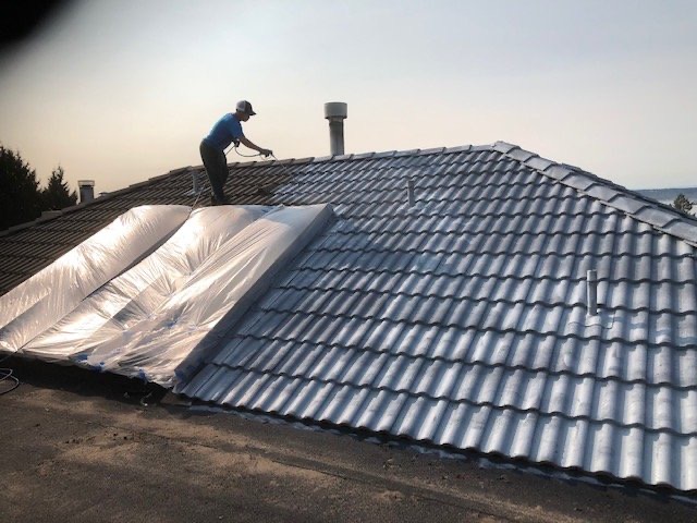 Concrete tile roof being stripped and underlaid